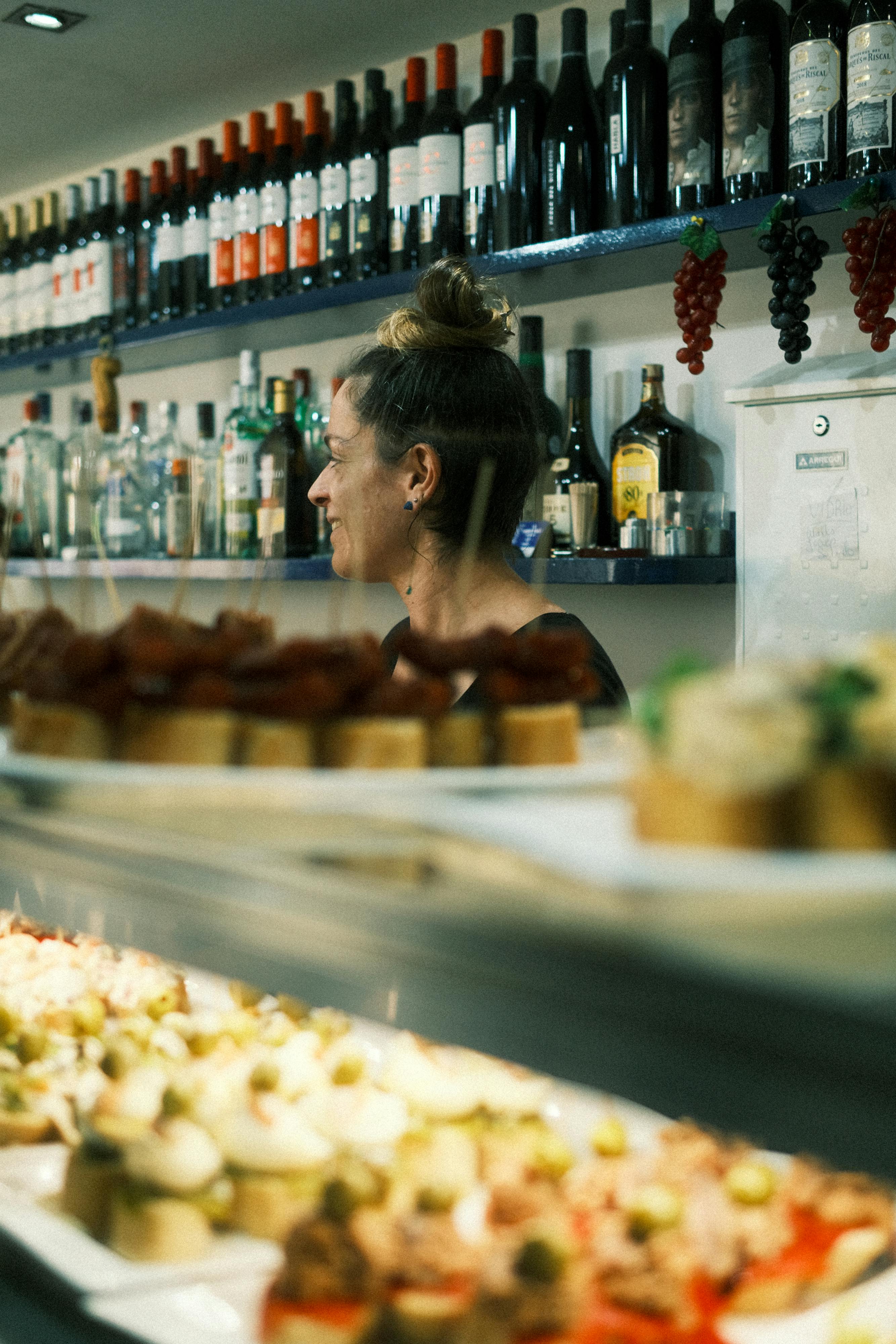 Tapas and wine bottles inside a Spanish bar, reflecting the relaxed food and drink culture of Murcia.